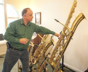 Tim Price talks about his contrabass saxophone. Dean Hare/Daily News