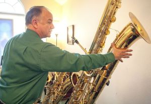 Tim Price talks about his contrabass saxophone. Dean Hare/Daily News