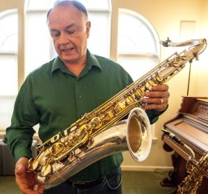 Tim Price talks about the engraving on this saxophone, which depict New York city scenes, including a skyline showing the Twin Towers. After the 9/11 terrorist attacks, the saxophone maker no longer uses those images on the instruments he makes. Dean Hare/Daily News